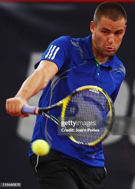 Mikhail Youzhny of Russia returns a backhand during his semi final match against Gilles Simon of France during the bet-at-home German Open Tennis...