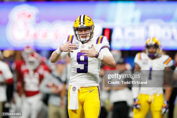 Quarterback Joe Burrow of the LSU Tigers celebrates a touchdown in the second quarter over the Oklahoma Sooners during the Chick-fil-A Peach Bowl at...
