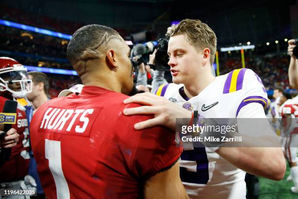 Quarterback Joe Burrow of the LSU Tigers and quarterback Jalen Hurts of the Oklahoma Sooners embrace after LSU Tigers wins the Chick-fil-A Peach Bowl...
