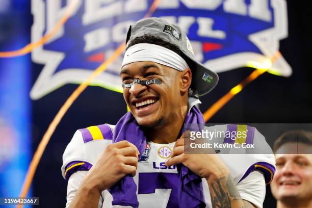 Safety Grant Delpit of the LSU Tigers celebrate on the podium after winning the Chick-fil-A Peach Bowl 28-63 over the Oklahoma Sooners at...