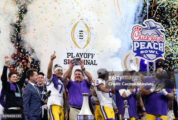 Head coach Ed Orgeron of the LSU Tigers celebrates on the podium after winning the Chick-fil-A Peach Bowl 28-63 over the Oklahoma Sooners at...
