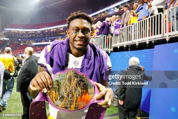 Linebacker Patrick Queen of the LSU Tigers poses with a faux championship belt after winning the Chick-fil-A Peach Bowl 28-63 over the Oklahoma...