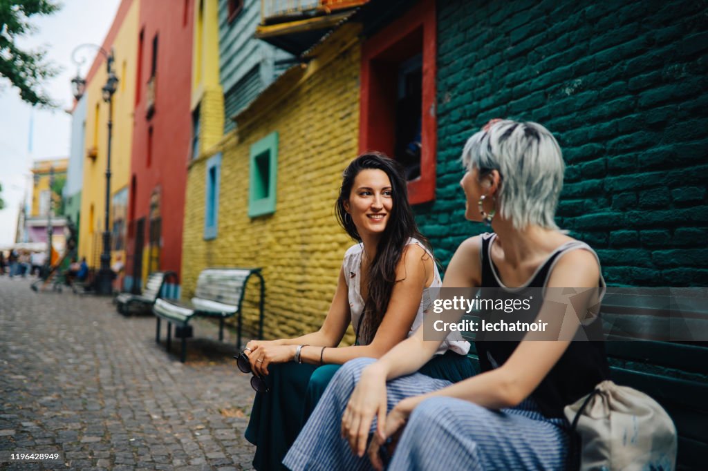 Girls sitting in front of a vintage house