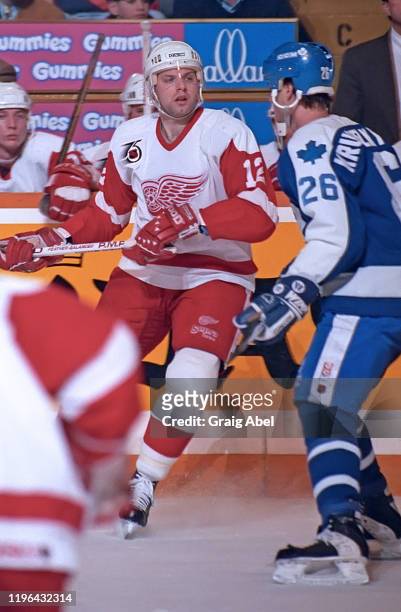 Jimmy Carson of the Detroit Red Wings skates against Mike Krushelnyski of the Toronto Maple Leafs during NHL game action on February 11, 1992 at...