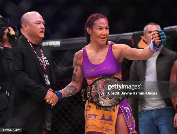 Cris Cyborg is congratulated by Bellator president Scott Coker after defeating Julia Budd in their featherweight world title fight at The Forum on...