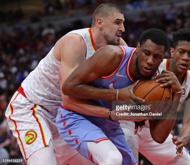 Alex Len of the Atlanta Hawks pressures Thaddeus Young of the Chicago Bulls at the United Center on December 28, 2019 in Chicago, Illinois. The Bulls...