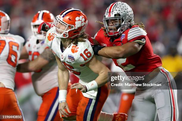 Chase Young of the Ohio State Buckeyes pursues Trevor Lawrence of the Clemson Tigers in the first half during the College Football Playoff Semifinal...