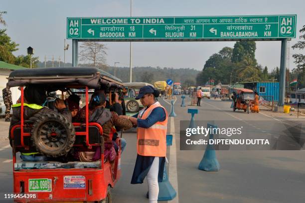 An Indian Sashastra Seema Bal personal checks travellers coming from Nepal to India during a Corona virus information camp at an India-Nepal border...