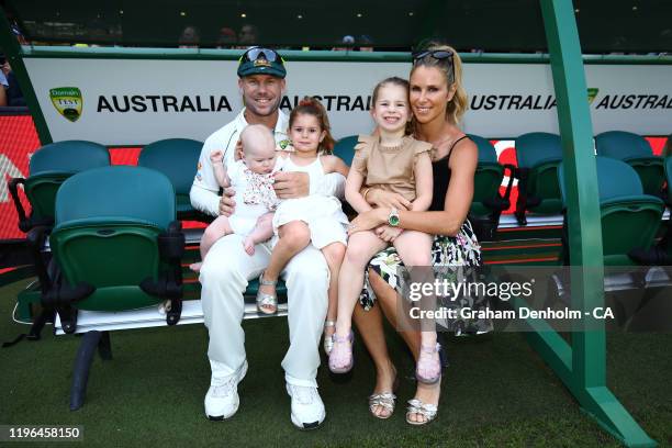 David Warner of Australia and wife Candice Warner embrace their daughters following victory in the Second Test match in the series between Australia...