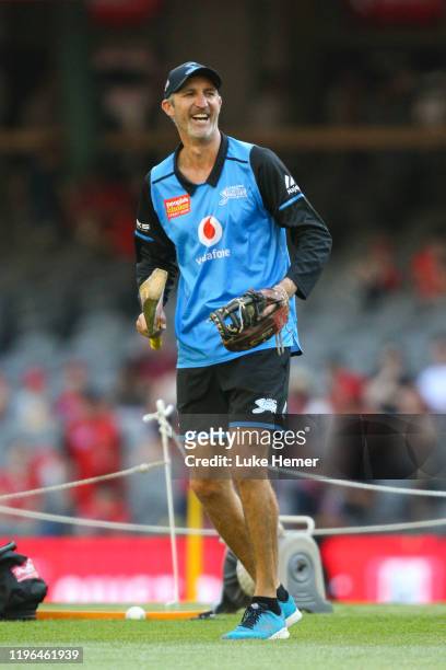 Jason Gillespie coach of the Strikers conducts fielding practice during the Big Bash League match between the Melbourne Renegades and the Adelaide...