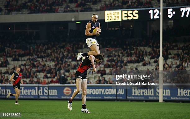 Andrew Walker of the Blues takes a mark over Jake Carlisle of the Bombers during the round 18 AFL match between Essendon Bombers and the Carlton...