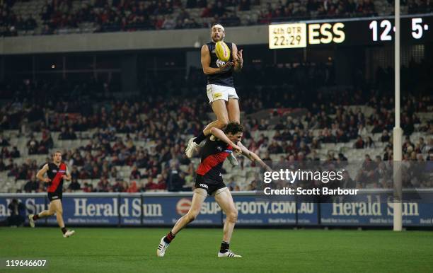 Andrew Walker of the Blues takes a mark over Jake Carlisle of the Bombers during the round 18 AFL match between Essendon Bombers and the Carlton...