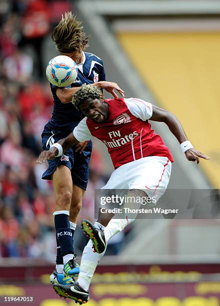 Martin Lanig of Koeln battles for the ball with Alex Song of Arsenal during the International pre-season friendly match between 1.FC Koeln and...