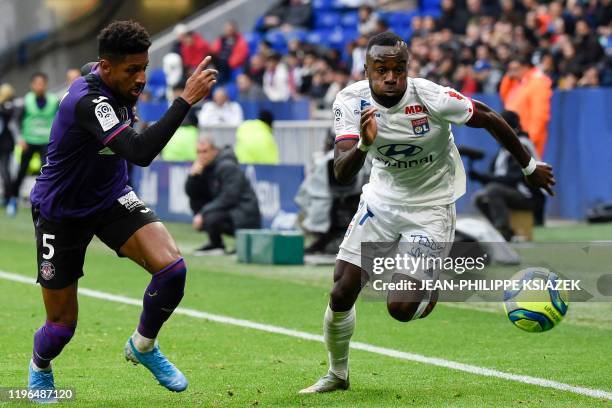 Toulouse's French defender Steven Moreira fights for the ball with Lyon's Ivorian forward Maxwel Cornet during the French L1 football match between...