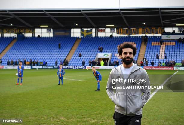 Liverpool's Egyptian midfielder Mohamed Salah walks around the pitch ahead of the English FA Cup fourth round football match between between...