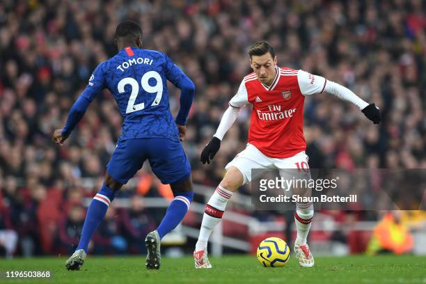 Mesut Ozil of Arsenal takes on Fikayo Tomori of Chelsea during the Premier League match between Arsenal FC and Chelsea FC at Emirates Stadium on...
