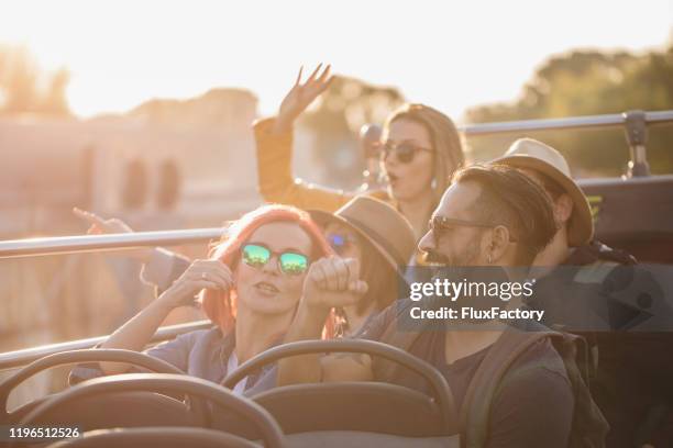 tourists exploring city on a tour bus - open top bus stock pictures, royalty-free photos & images