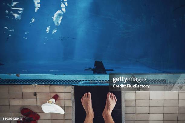 mature swimmer standing on a diving board - diving platform stock pictures, royalty-free photos & images