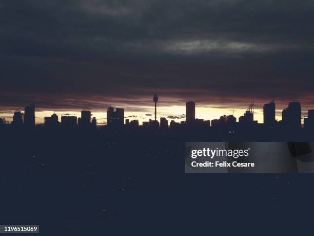 a silhouette of sydney cbd skyline cityscape against cloudy sky - town australia bildbanksfoton och bilder