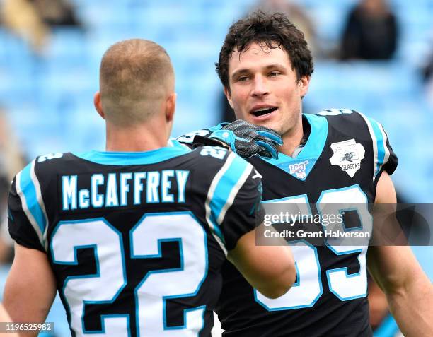 Christian McCaffrey and Luke Kuechly of the Carolina Panthers warms up during their game against the New Orleans Saints at Bank of America Stadium on...