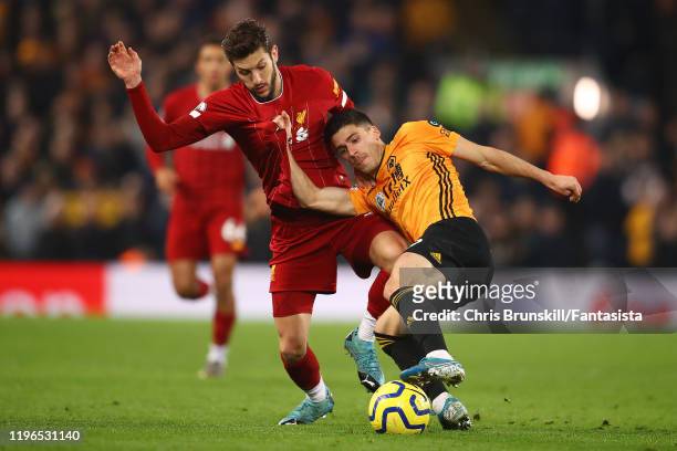 Adam Lallana of Liverpool in action with Ruben Vinagre of Wolverhampton Wanderers during the Premier League match between Liverpool FC and...