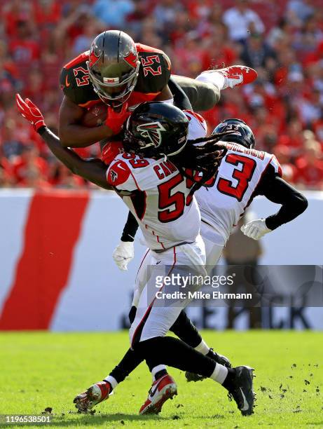 Peyton Barber of the Tampa Bay Buccaneers is tackled by De'Vondre Campbell of the Atlanta Falcons during a game at Raymond James Stadium on December...