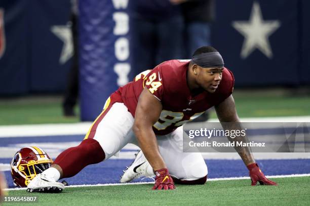 Daron Payne of the Washington Redskins stretches before the game against the Dallas Cowboys at AT&T Stadium on December 29, 2019 in Arlington, Texas.