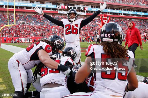 The Atlanta Falcons celebrate after Deion Jones intercepted a pass by Jameis Winston for a touchdown to defeat the Tampa Bay Buccaneers 28-22 in...