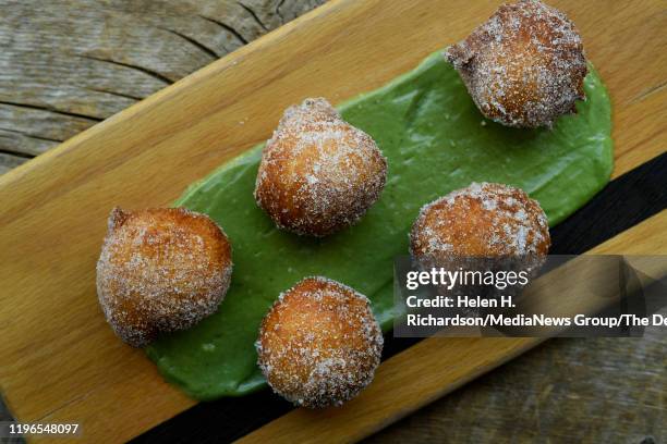 Zeppole are Sicilian ricotta donuts served with caradmom sugar and pistachio mousse at Spuntino Restaurant on June 27, 2019 in Denver, Colorado.