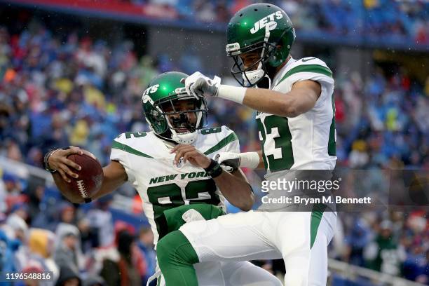 Jamison Crowder and Josh Malone of the New York Jets celebrate after scoring a touchdown during the fourth quarter of an NFL game against the Buffalo...