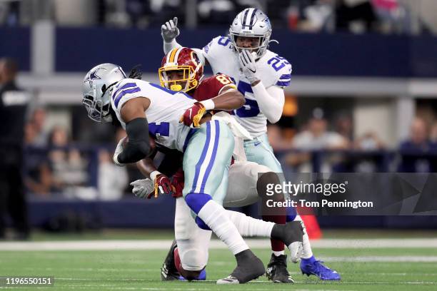 Jaylon Smith of the Dallas Cowboys is downed by Jeremy Sprinkle of the Washington Redskins after making an interception in the first quarter in the...