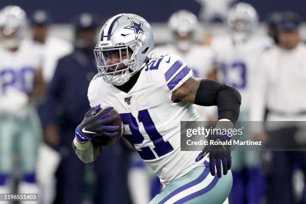 Ezekiel Elliott of the Dallas Cowboys runs with the ball in the first quarter against the Washington Redskins in the game at AT&T Stadium on December...