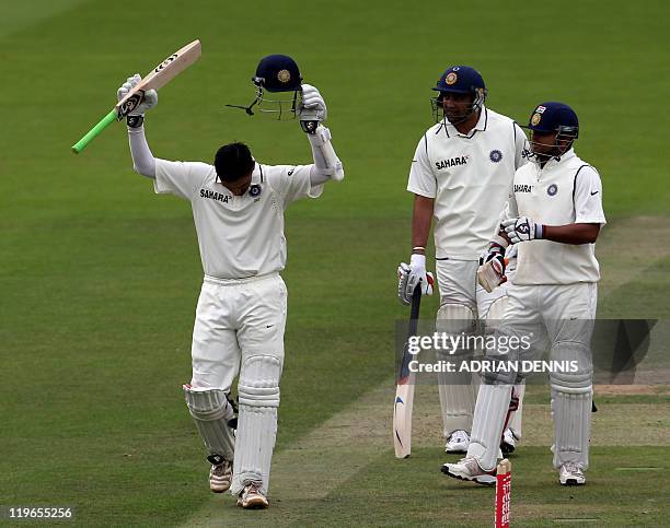 India's batsman Rahul Dravid celebrates scoring a century while teammate Suresh Raina and Zaheer Khan look on against England during day three of the...