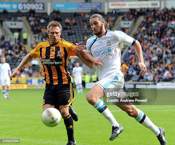 Andy Carroll of Liverpool competes with Nick Barmby of Hull City during a pre-season friendly between Hull City and Liverpool at KC Stadium on July...