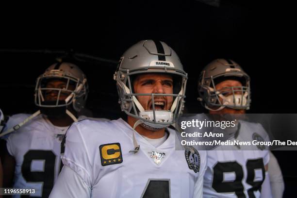 Derek Carr of the Oakland Raiders prepares to lead his team onto the field before the first quarter against the Denver Broncos on Sunday, December...