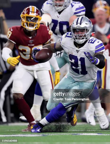 Ezekiel Elliott of the Dallas Cowboys runs with the ball in the second quarter against the Washington Redskins in the game at AT&T Stadium on...