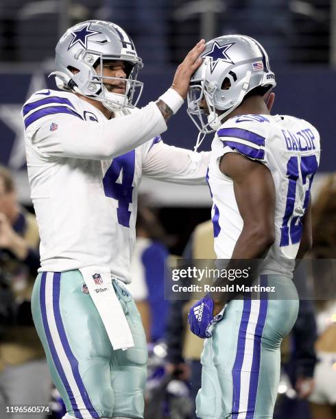 Dak Prescott and Michael Gallup of the Dallas Cowboys celebrate after scoring a touchdown in the third quarter against the Washington Redskins in the...