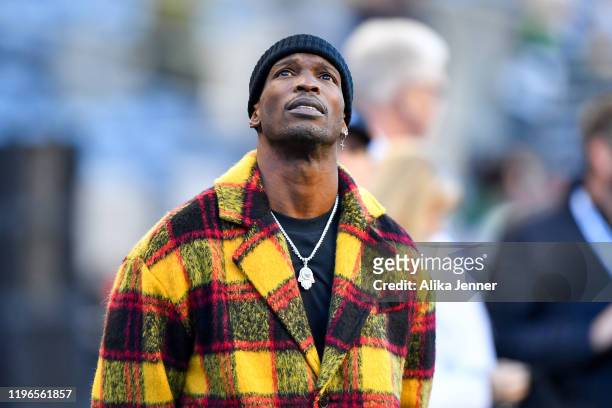 Former NFL wide receiver Chad Johnson looks at the scoreboard before the game between the Seattle Seahawks and the San Francisco 49ers at CenturyLink...