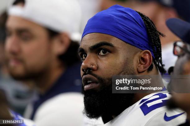 Ezekiel Elliott of the Dallas Cowboys looks on from the bench in the third quarter against the Washington Redskins in the game at AT&T Stadium on...