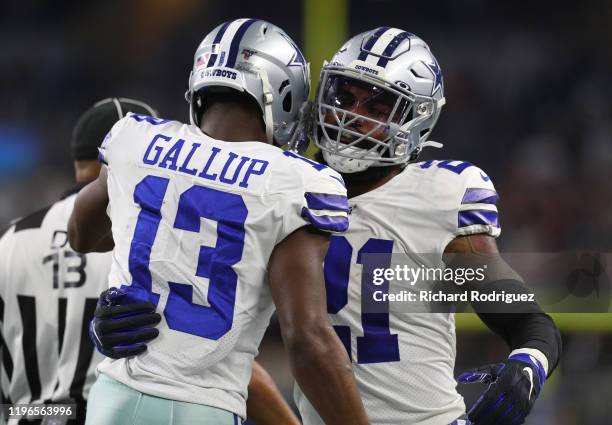 Michael Gallup and Ezekiel Elliott of the Dallas Cowboys celebrate the touchdown by Gallup in the third quarter against the Washington Redskins at...