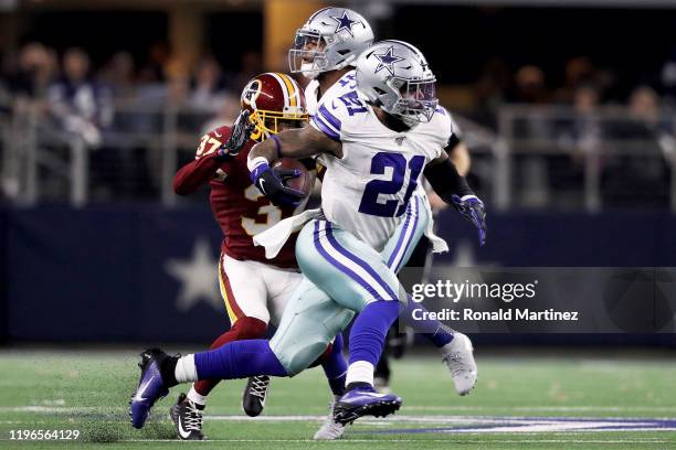 Ezekiel Elliott of the Dallas Cowboys runs with the ball in the third quarter against the Washington Redskins in the game at AT&T Stadium on December...