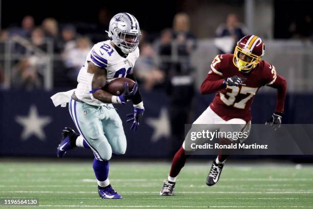 Ezekiel Elliott of the Dallas Cowboys runs with the ball in the third quarter against the Washington Redskins in the game at AT&T Stadium on December...