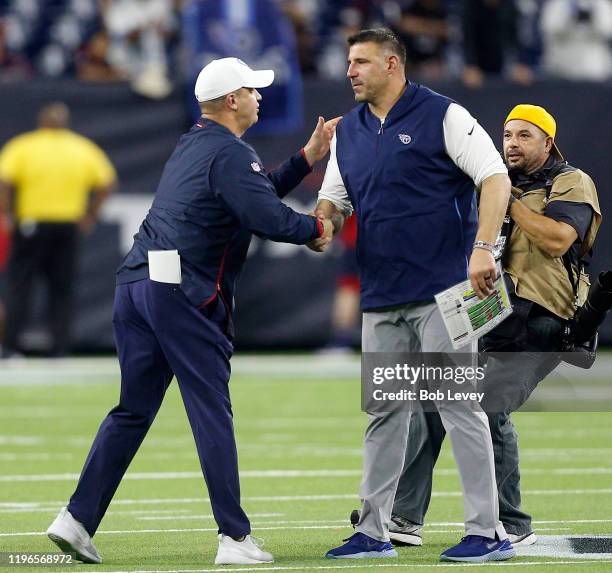 Head coach Mike Vrabel of the Tennessee Titans shakes hands with head coach Bill O'Brien of the Houston Texans at NRG Stadium on December 29, 2019 in...