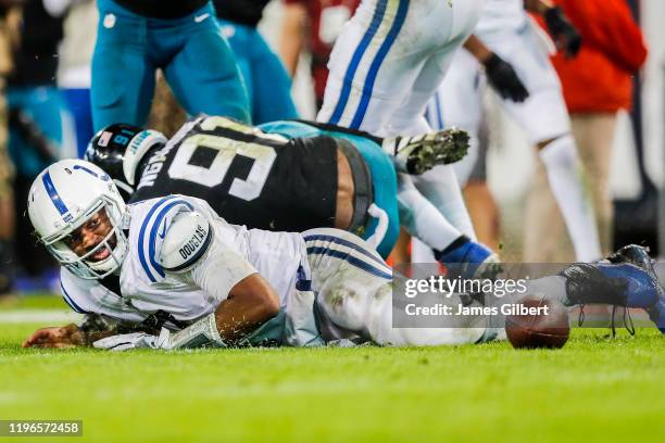 Jacoby Brissett of the Indianapolis Colts looks at a loose ball after fumbling during the fourth quarter of a game against the Jacksonville Jaguars...