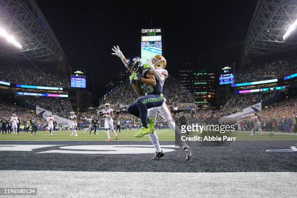 Wide receiver Tyler Lockett of the Seattle Seahawks makes a touchdown catch against cornerback Ahkello Witherspoon of the San Francisco 49ers during...