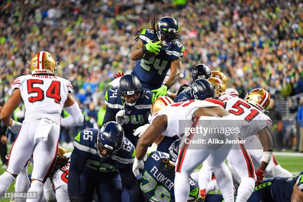 Marshawn Lynch of the Seattle Seahawks leaps and scores during the during the fourth quarter of the game against the San Francisco 49ers at...