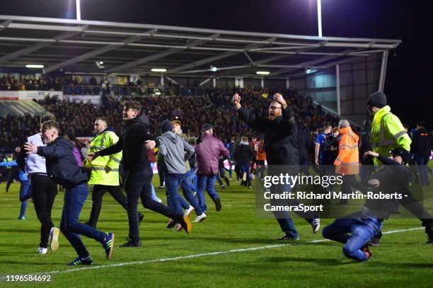 Shrewsbury Town fans invade the pitch as the final whistle is blown during the FA Cup Fourth Round match between Shrewsbury Town and Liverpool at New...