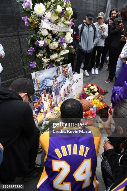 Flowers and tributes are left at a makeshift memorial for former NBA player Kobe Bryant outside the 62nd Annual GRAMMY Awards at STAPLES Center on...