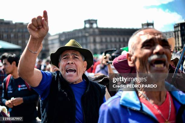 Supporters of Mexican President Andres Manuel Lopez Obrador shout slogans at people participating in a march for peace in Mexico City, on January 26,...