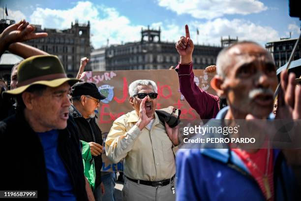 Supporters of Mexican President Andres Manuel Lopez Obrador shout slogans at people participating in a march for peace in Mexico City, on January 26,...